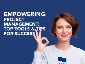 A woman giving a nice sign wearing ITAdOn's T shirt and from her left the title of the blog "Empowering Project Management: Top Tools & Tips for Success"