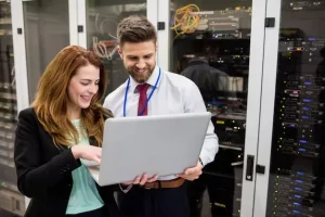 Business woman and man looking at the report shared by Fully managed it support service agent