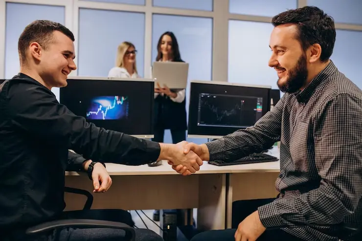 Two people shaking hands after a successful IT Hardware procurement service from ITAdOn